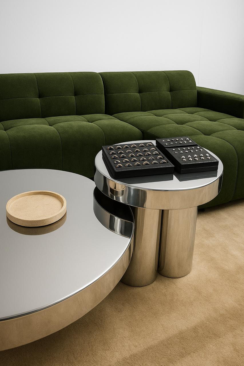 A green tufted sofa with a silver coffee table displaying trays of ring jewelry diamond, including a diamond engagement rings.