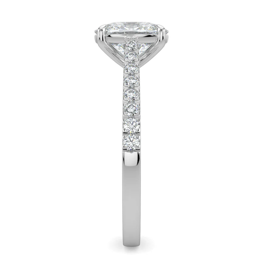 Side view of a silver lab diamond ring featuring small diamonds on the band and a larger central diamond of oval shape in four prong setting.