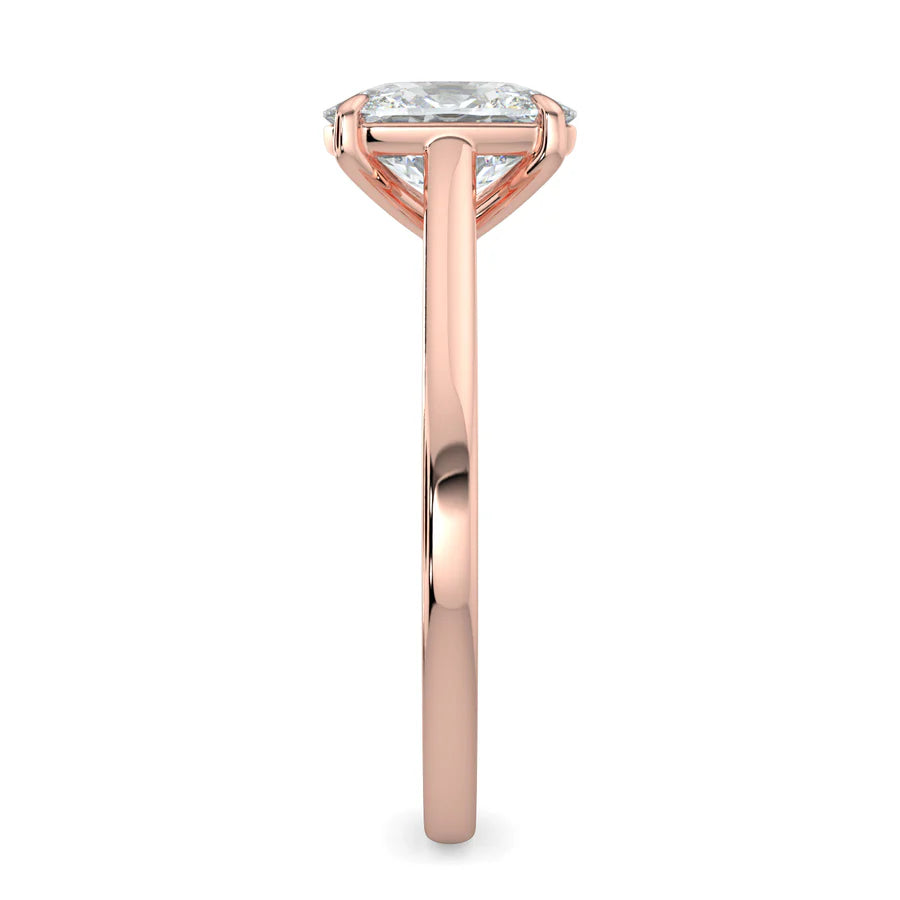 Side view of a rose gold solitaire lab diamond engagement ring featuring a round cut diamond in four-prong setting.