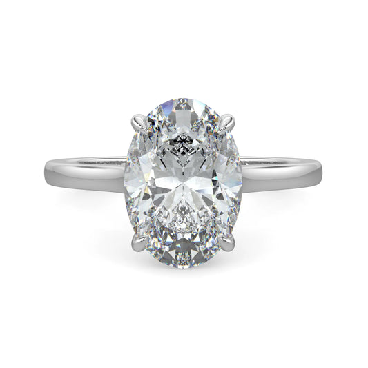 Top view of a silver lab diamond ring featuring a central diamond in a four-prong setting, with a polished band.