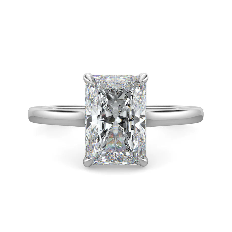 Top view of a silver lab diamond ring featuring a larger central diamond of round brilliant cut in a four-prong setting.