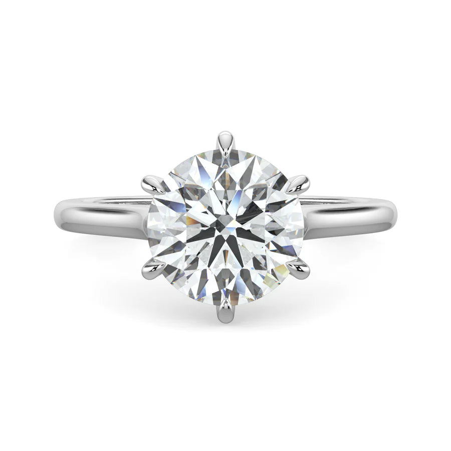 Side view of a cathedral solitaire engagement ring featuring a sleek silver band with 6 prong setting.