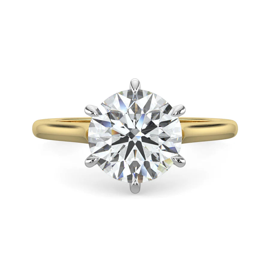 Side view of a cathedral solitaire engagement ring with a white gold band, showcasing a single round diamond set in a raised prong setting.