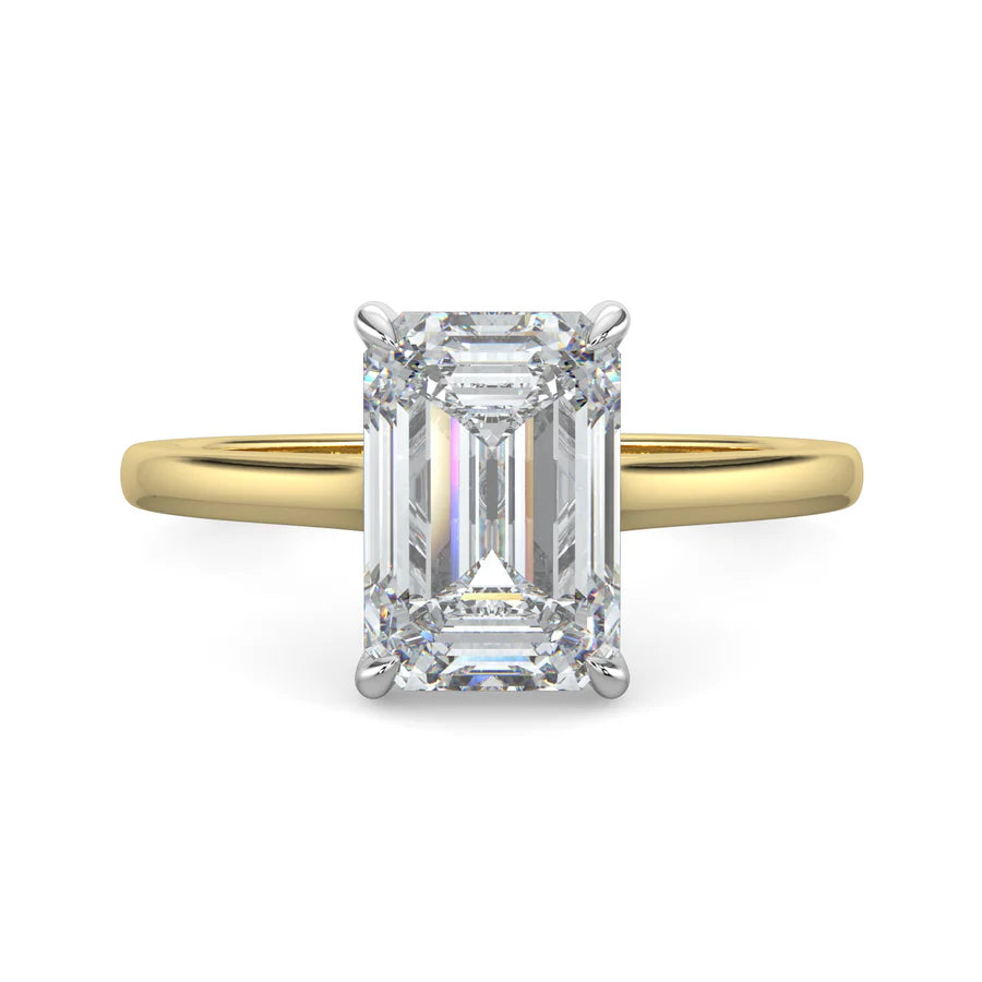 Top view of a gold lab grown diamond ring with radiant-cut diamond in a four-prong setting and silver color polished band.