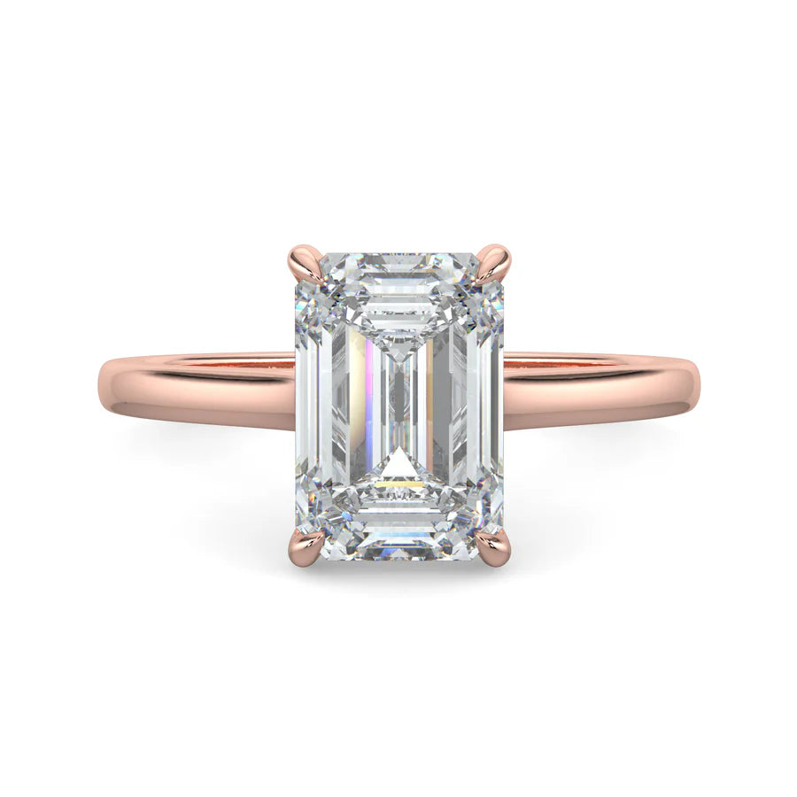 Top view of a rose gold lab grown diamond ring with radiant-cut diamond in a four-prong setting and rose gold color polished band.