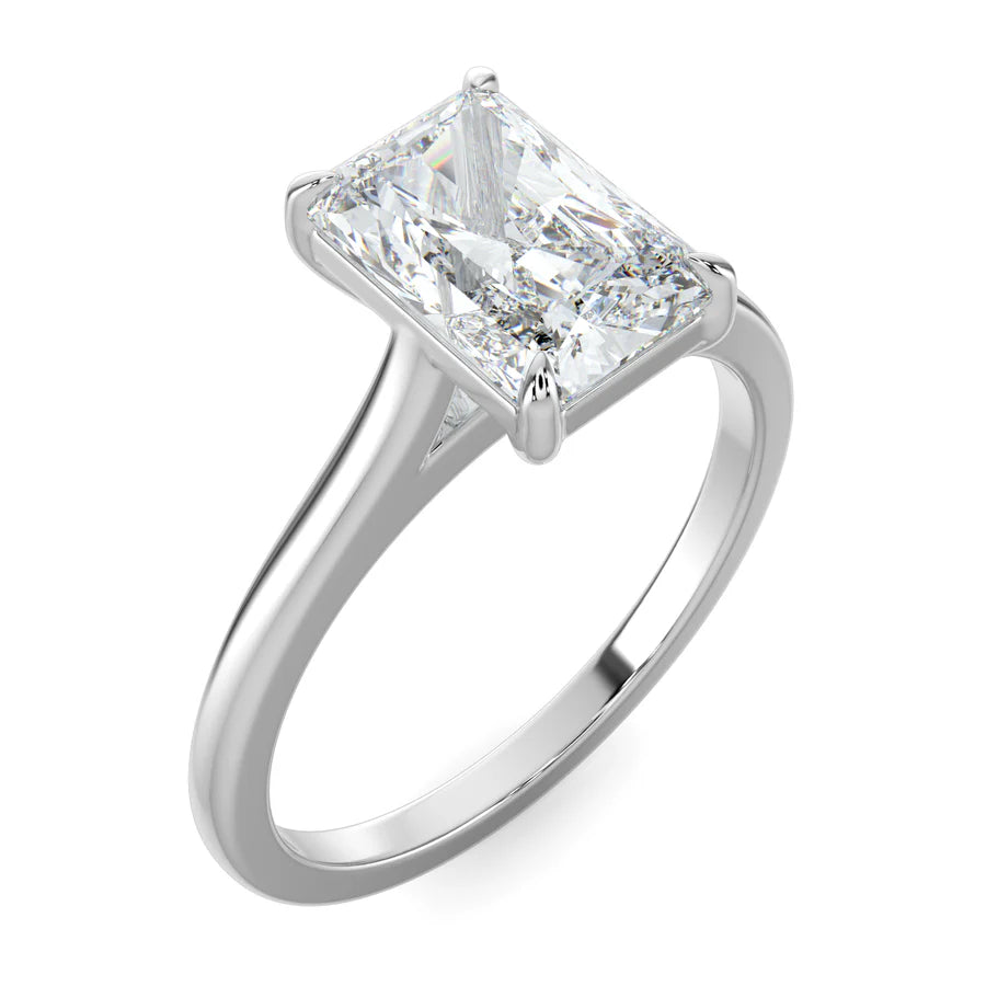 Angled view of a silver lab diamond ring featuring a smooth band and a larger central diamond of round cut in a four-prong setting.