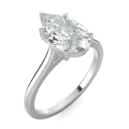 Angled view of a silver lab diamond ring featuring a polished band and a larger diamond in a five-prong setting.
