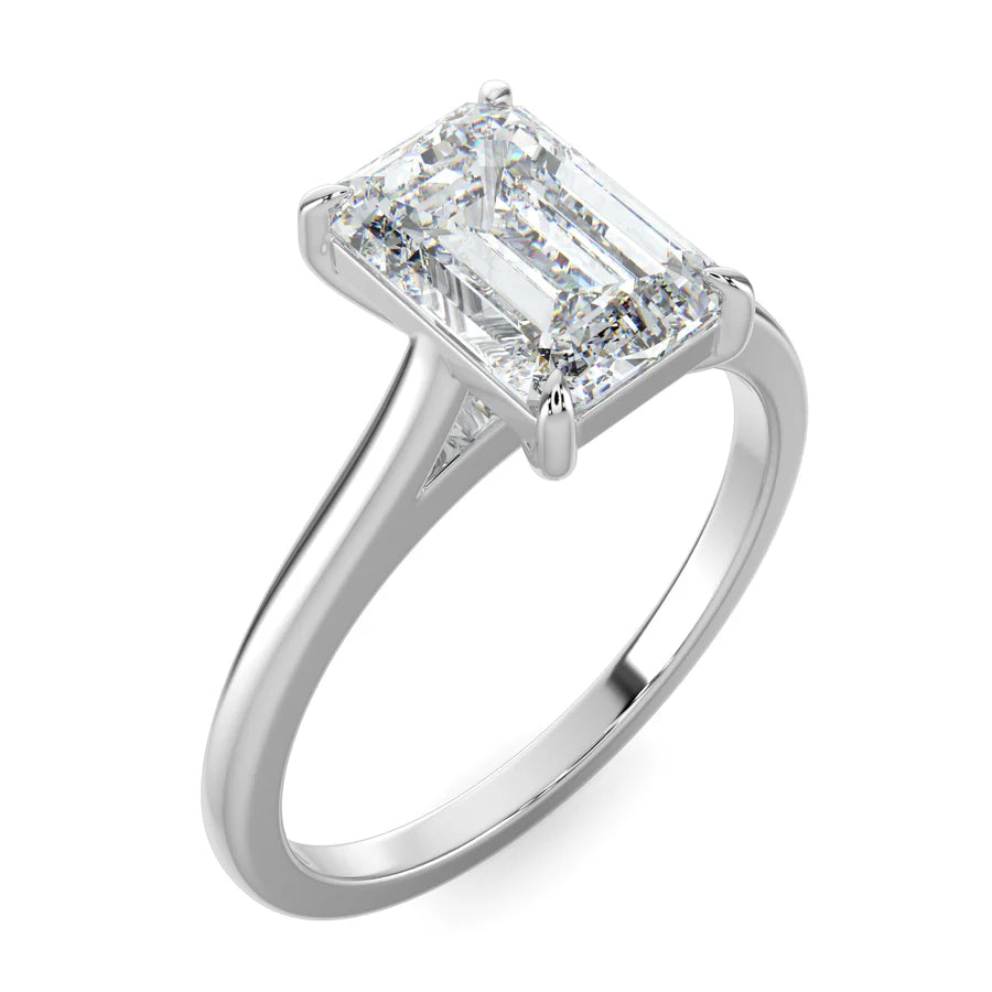 Angled view of a lab grown diamond ring with radiant-cut diamond in a four-prong setting and polished silver band.