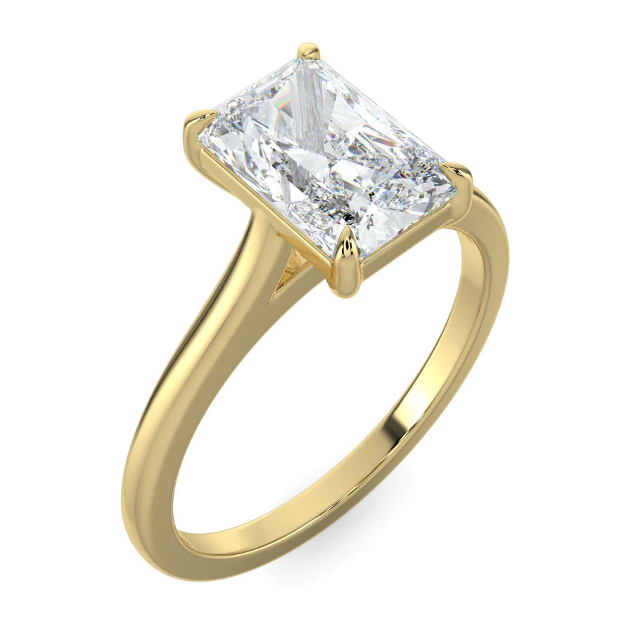 Angled view of lab diamond ring in yellow gold, featuring a white diamond held securely by four prongs.