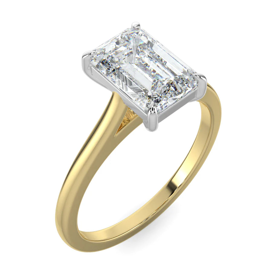 Angled view of a lab grown diamond ring with radiant-cut diamond in a silver four-prong setting and gold polished band.