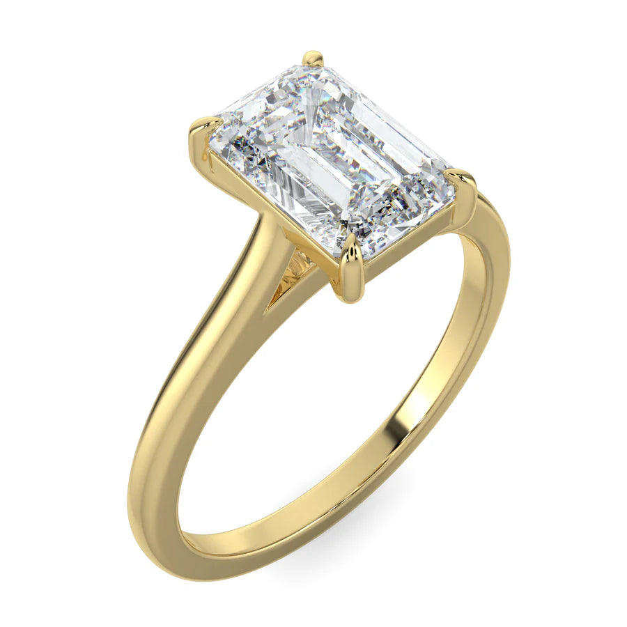 Angled view of a gold lab grown diamond ring with radiant-cut diamond in a four-prong setting and  polished band.