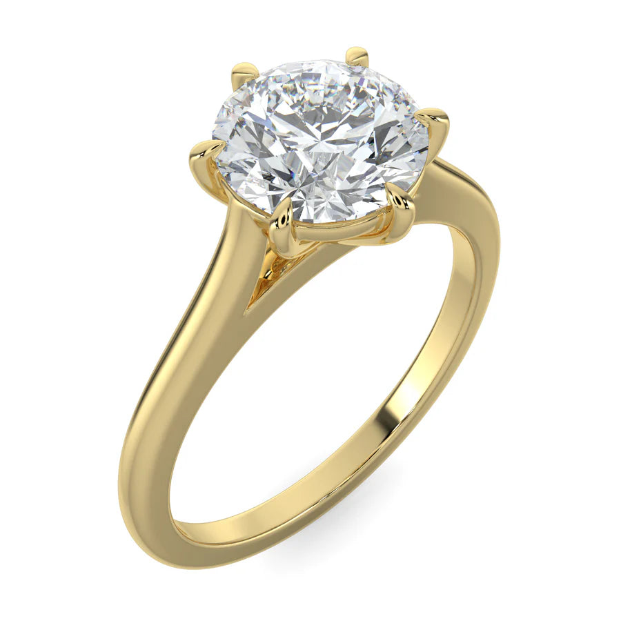 Angled top view of a cathedral-style solitaire engagement ring in yellow gold, featuring a round white diamond secured by six prongs. 