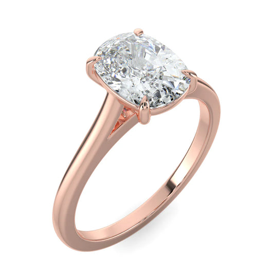 Angled view of a rose gold solitaire lab diamond engagement ring featuring an oval cut diamond in four-prong setting.