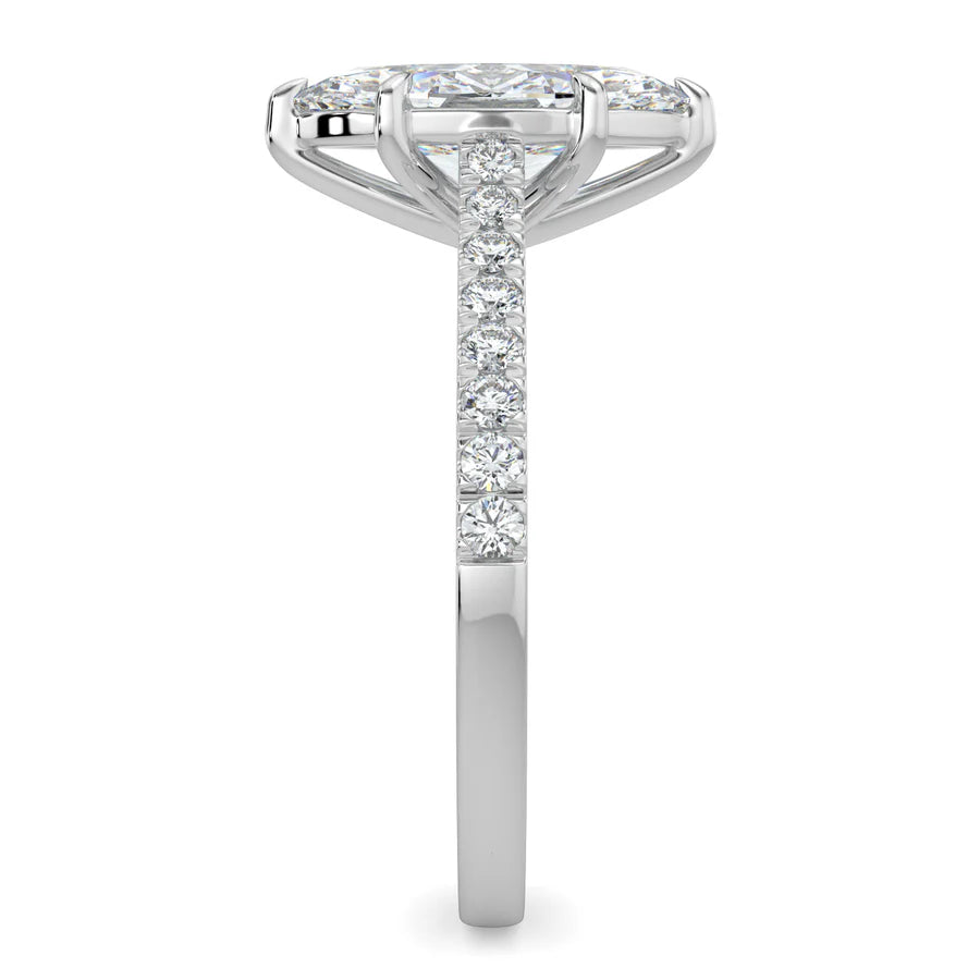 Side view of a silver lab diamond ring featuring small diamonds on the band and a larger central diamond of pear shape in six prong setting.