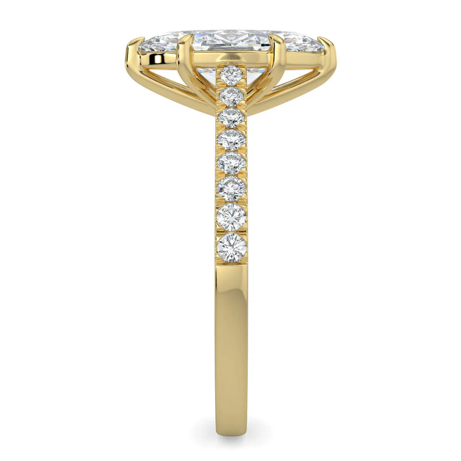 Side view of a gold lab diamond ring featuring small diamonds on the band and a larger central diamond of pear shape in six prong setting.