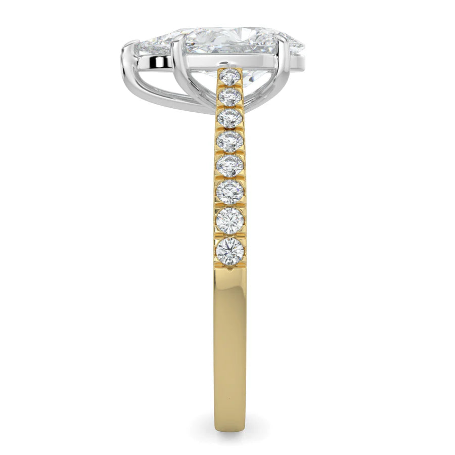 Side view of a pear shaped lab diamond ring in gold color featuring small diamonds on the band and a larger central diamond in silver color five prong setting.