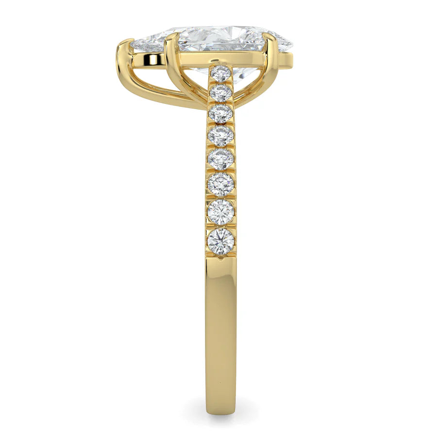 Side view of a pear shaped lab diamond ring in gold color featuring small diamonds on the band and a larger central diamond in  in five prong setting.