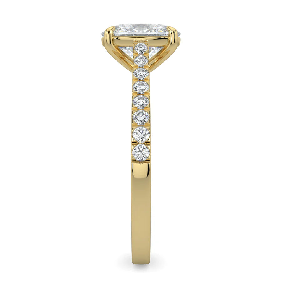 Side view of a gold lab diamond ring featuring small diamonds on the band and a larger central diamond in six prong setting.