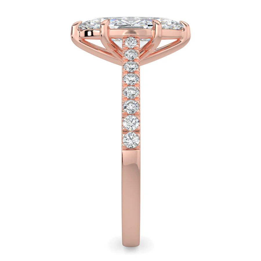 Side view of a rose gold lab diamond ring featuring small diamonds on the band and a larger central diamond of pear shape in six prong setting.