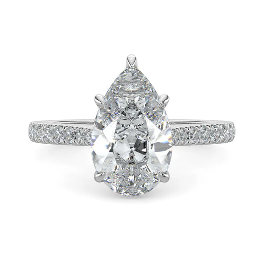 A pear shaped silver color lab diamond ring featuring small diamonds on the band and a larger central diamond in  in five prong setting.