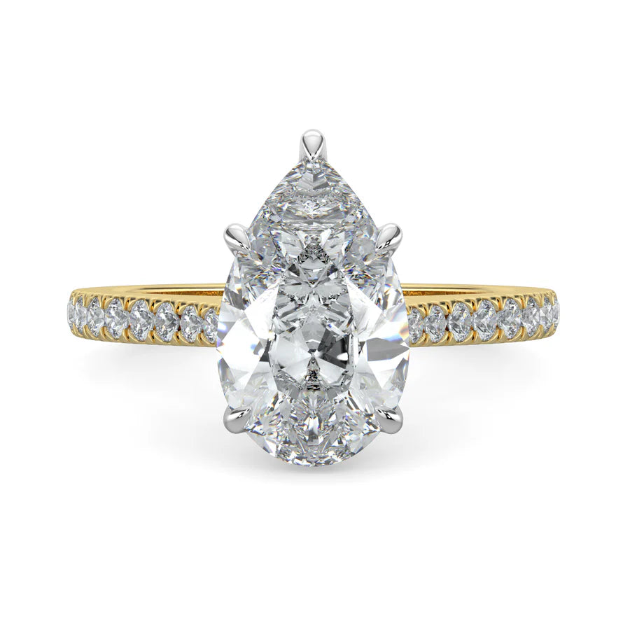 A pear shaped lab diamond ring in gold color featuring small diamonds on the band and a larger central diamond in  in silver color five prong setting.