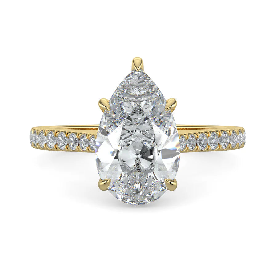 A pear shaped lab diamond ring in gold color featuring small diamonds on the band and a larger central diamond in  in five prong setting.