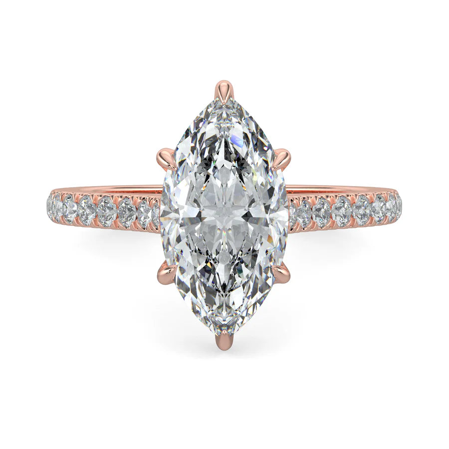 A rose gold lab diamond ring featuring small diamonds on the band and a larger central diamond of pear shape in six prong setting.