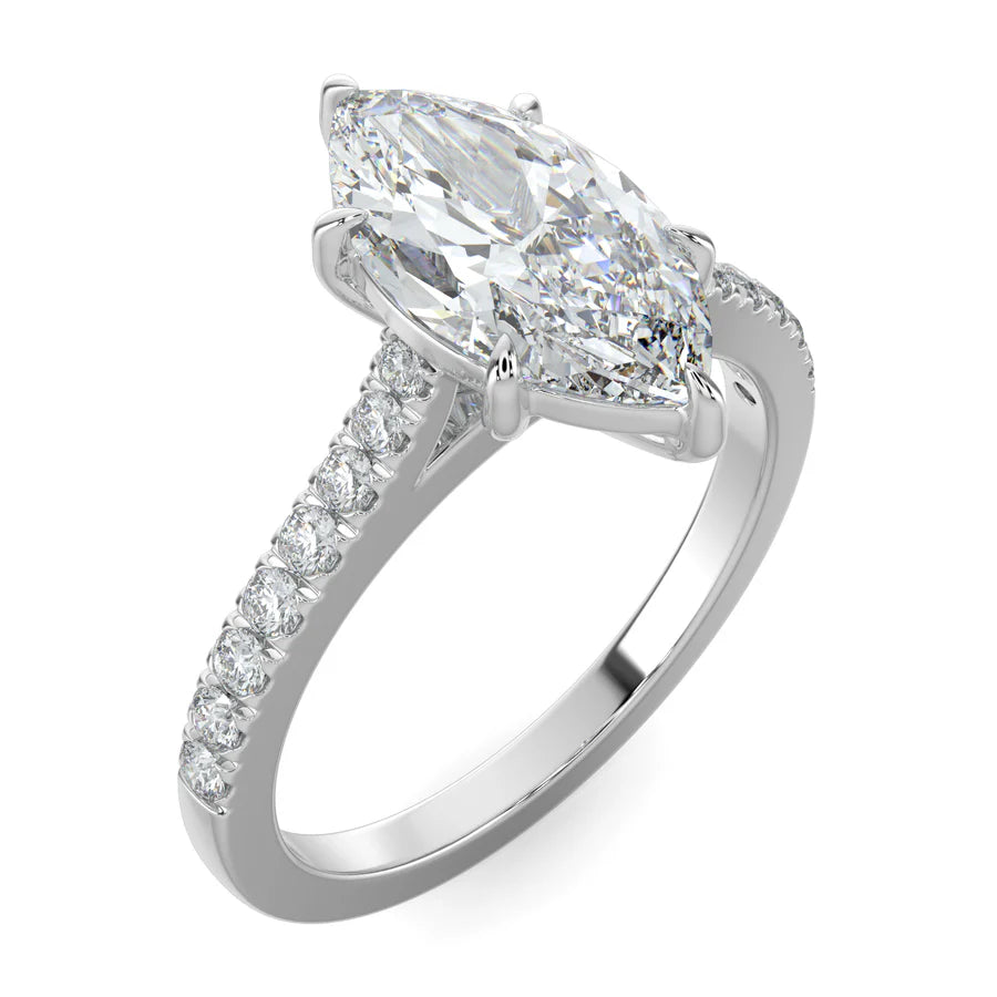 Angled view of a silver lab diamond ring featuring small diamonds on the band and a larger central diamond of pear shape in six prong setting.