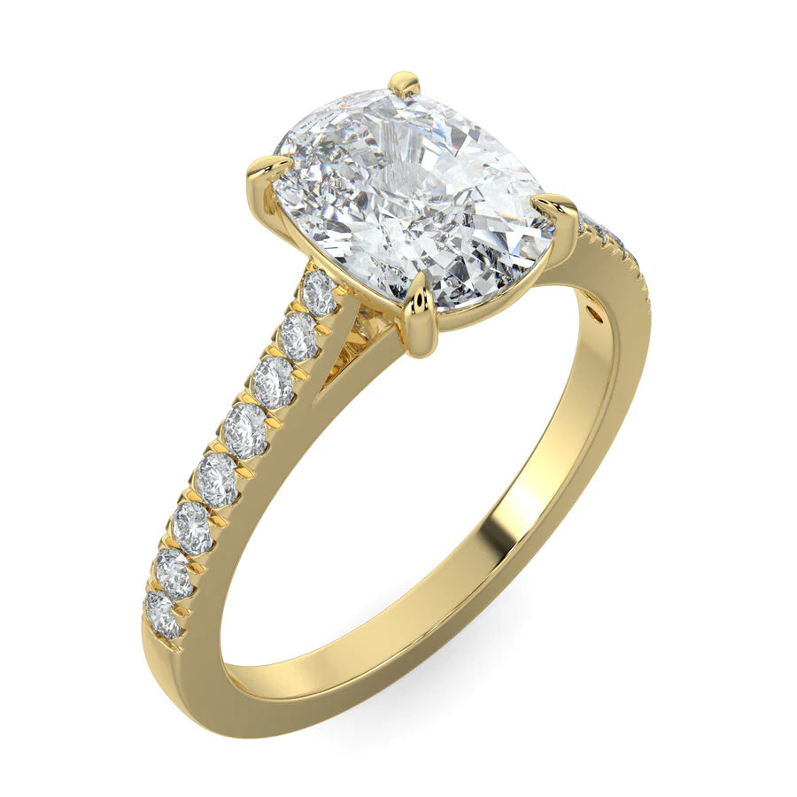 Angled view of a gold lab diamond ring featuring small diamonds on the band and a larger central diamond of oval shape in four prong setting.