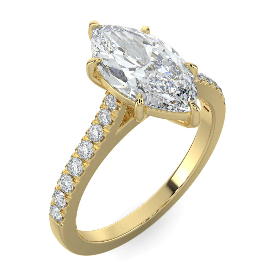 Angled view of a gold lab diamond ring featuring small diamonds on the band and a larger central diamond of pear shape in six prong setting.