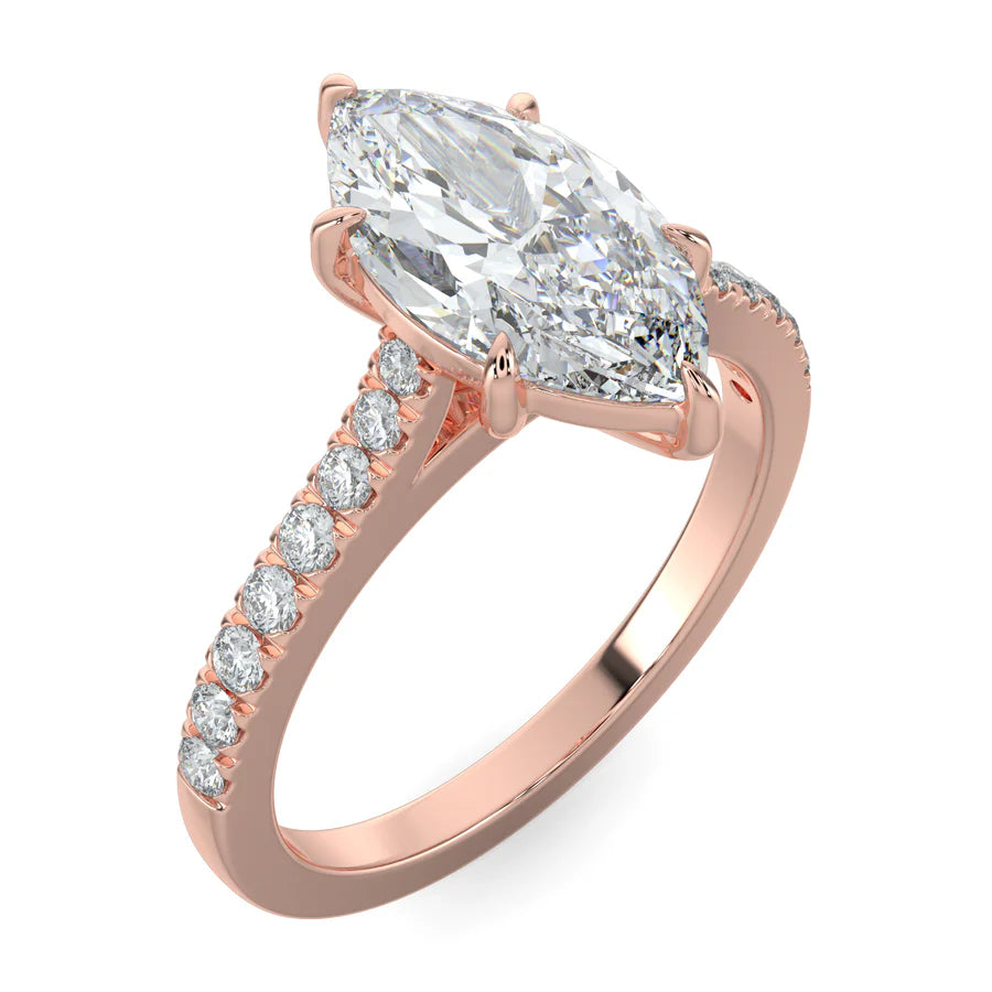 Angled view of a rose gold lab diamond ring featuring small diamonds on the band and a larger central diamond of pear shape in six prong setting.