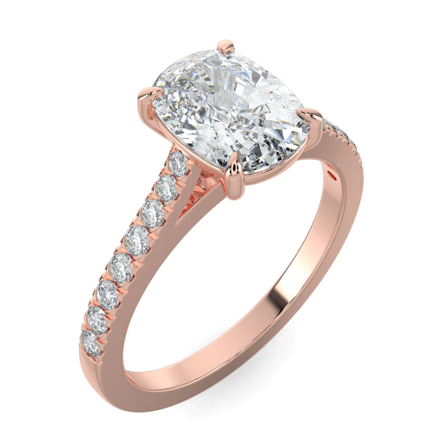 Angled view of a rose gold lab diamond ring featuring small diamonds on the band and a larger oval shape central diamond in six prong setting.