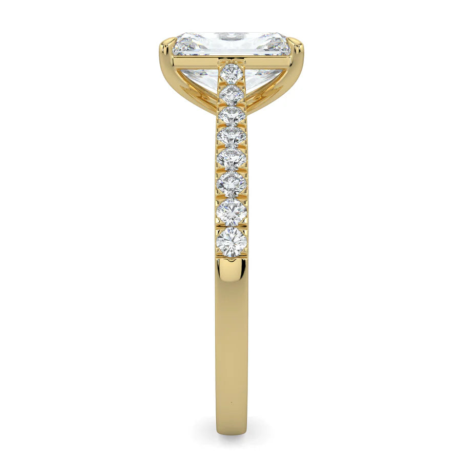 Side view of a gold lab diamond ring featuring small diamonds on the band and a larger central diamond in  in four prong setting.