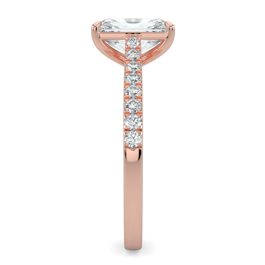 Side view of a rose gold lab diamond ring featuring small diamonds on the band and a larger central diamond in  in four prong setting.