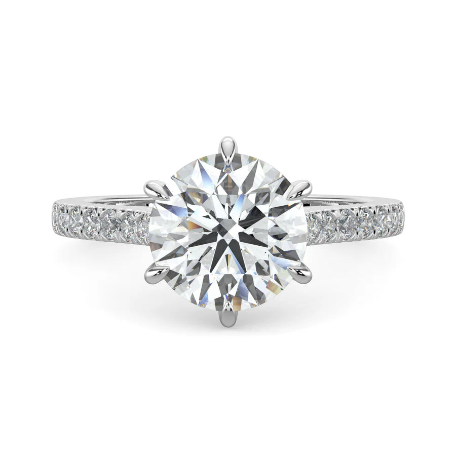 A round lab diamond ring in silver color featuring small diamonds on the band and a larger central diamond in six prong setting.