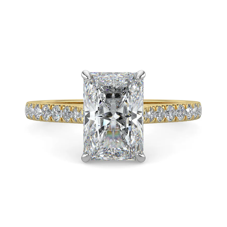 Gold color lab diamond ring featuring small diamonds on the band and a larger square shaped central diamond in  in silver color four prong setting.