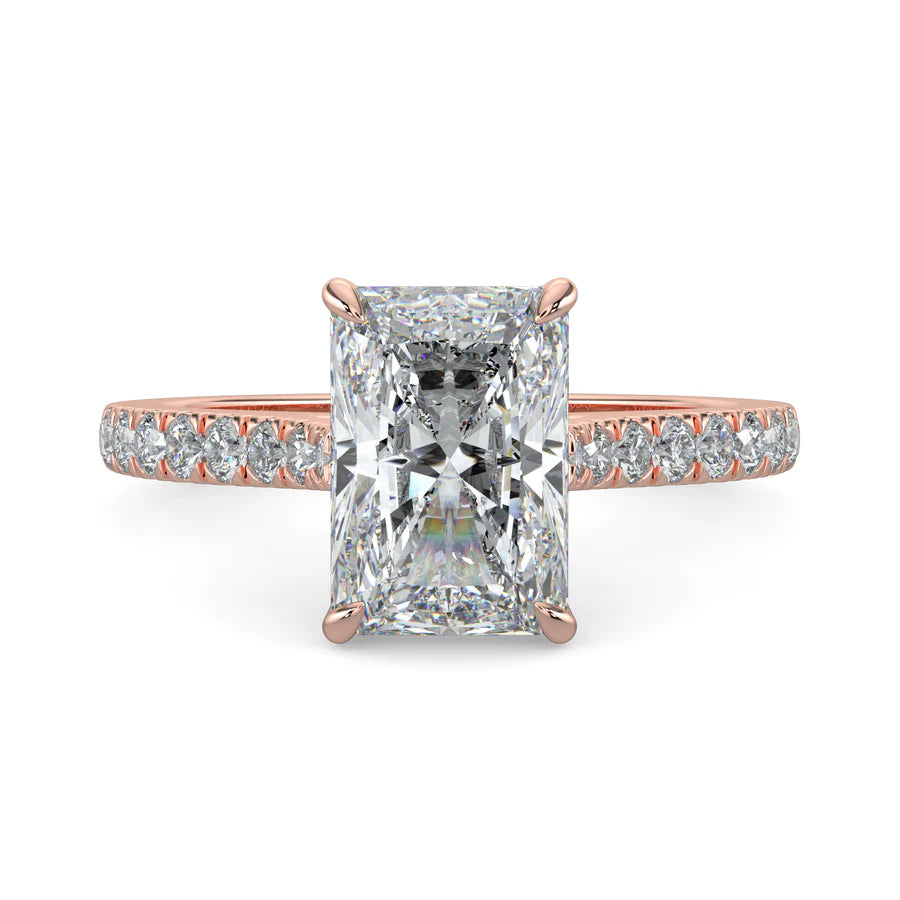 Rose gold color lab diamond ring featuring small diamonds on the band and a larger square shaped central diamond in  in four prong setting.