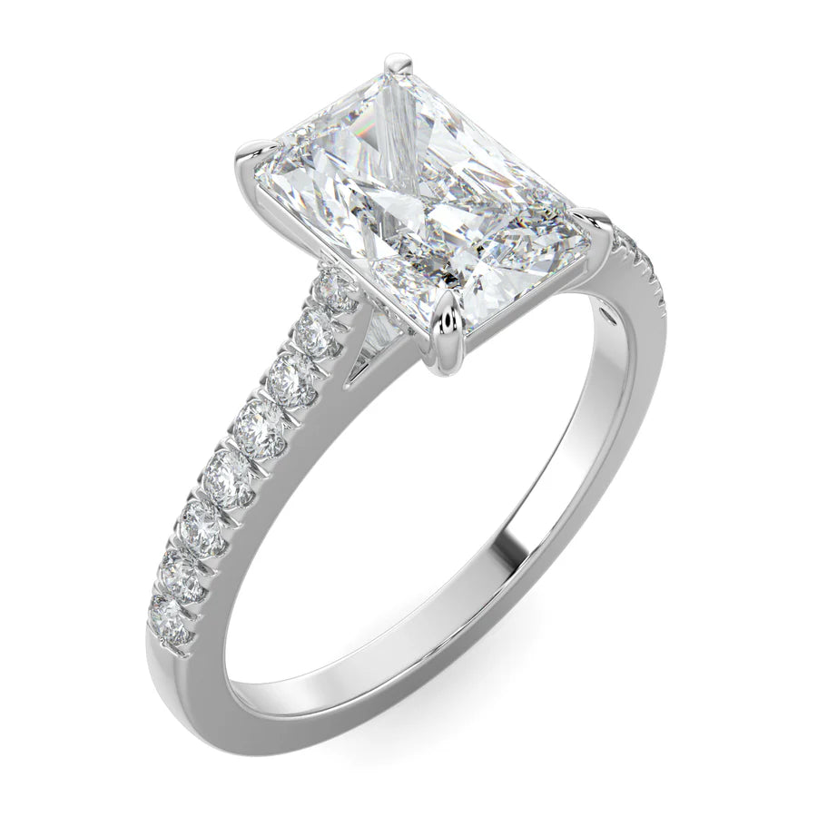 Angled view of a silver lab diamond ring featuring small diamonds on the band and a larger square shaped central diamond in  in four prong setting.