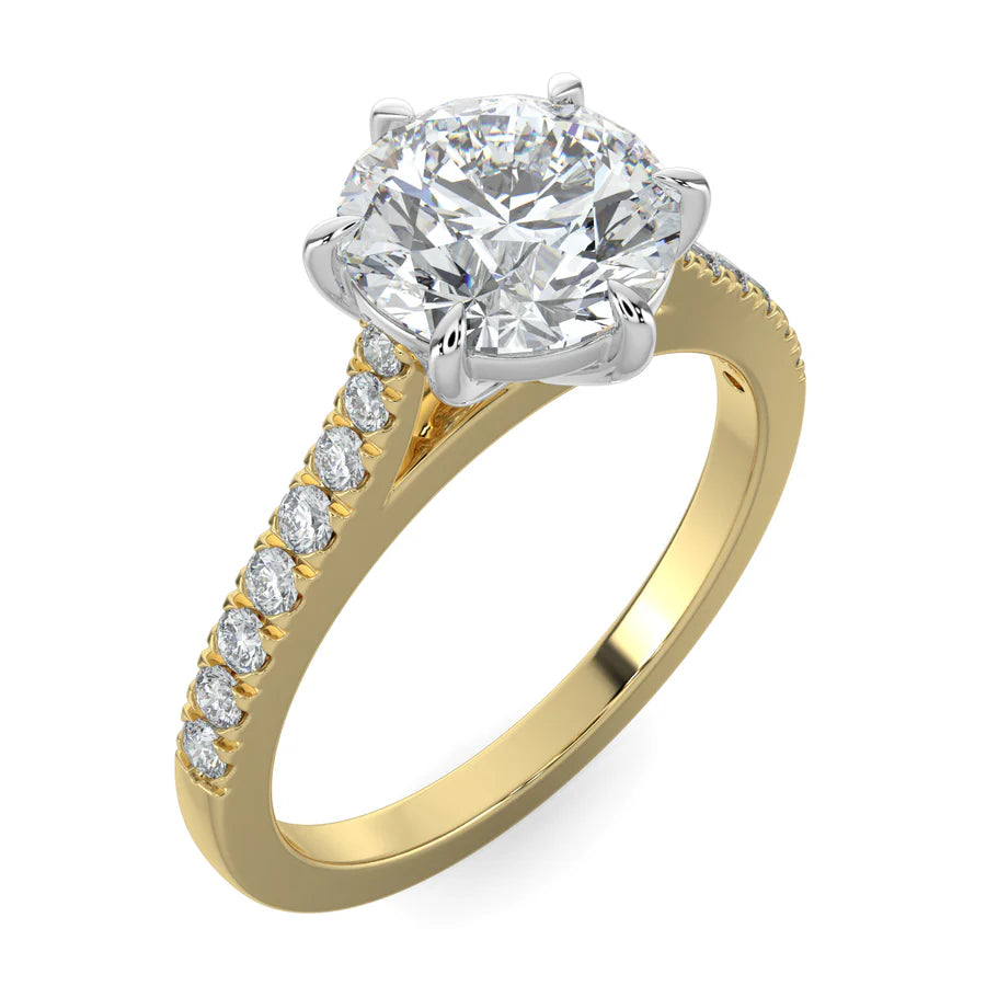 Angled view of a round lab diamond ring in gold color featuring small diamonds on the band and a larger central diamond in silver color six prong setting.