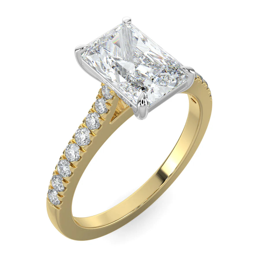 Angled view of a gold lab diamond ring featuring small diamonds on the band and a larger square shaped central diamond in  in silver color four prong setting.