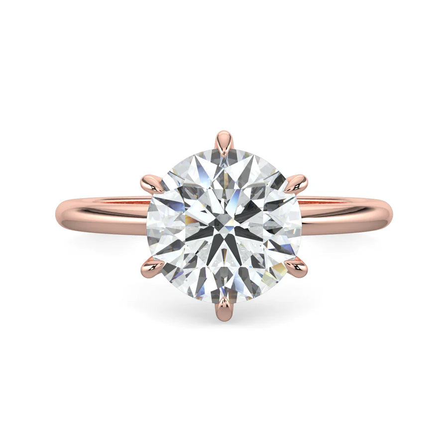 Top view of rose gold lab diamond ring featuring a diamond on round polished band in six prong setting.