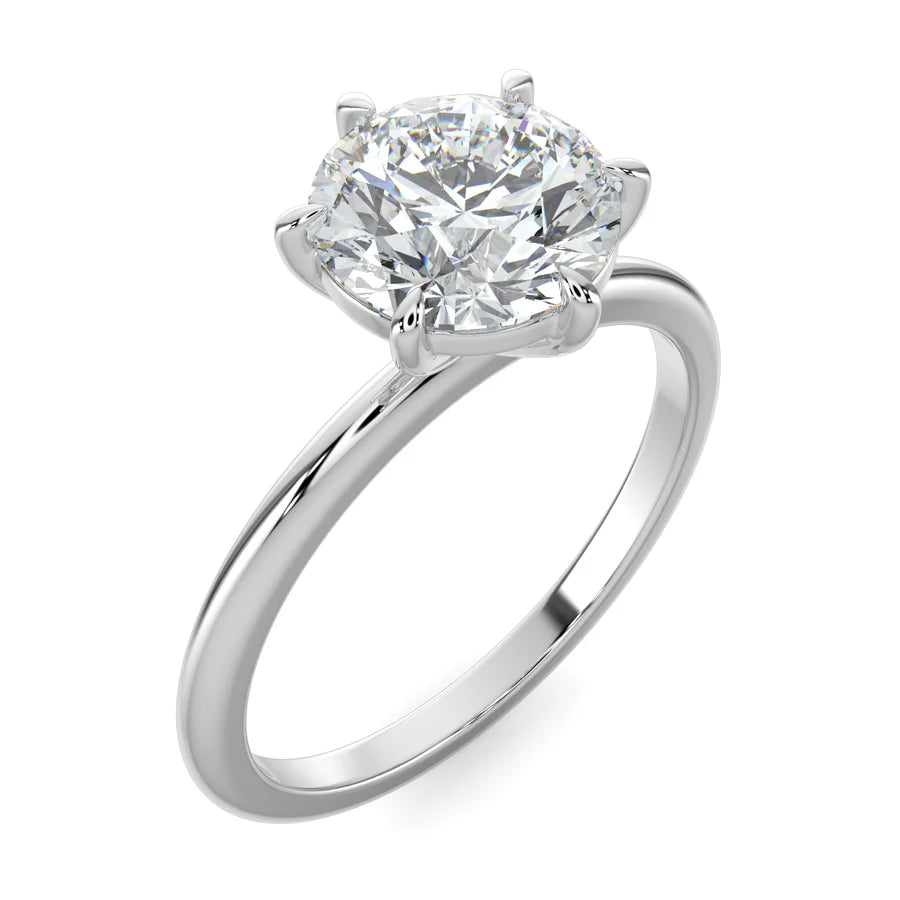 Angled view of silver lab diamond ring featuring a diamond on round polished band in six prong setting.